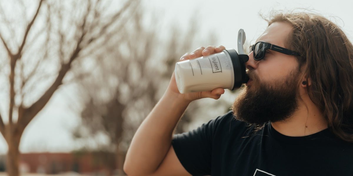 Man drinks coffee protein shake. 