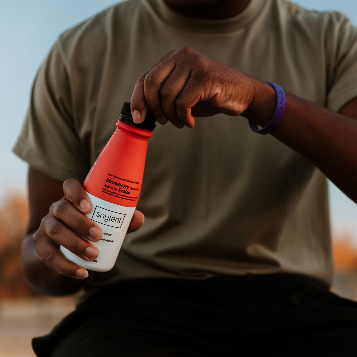 Person holding Soylent Drink Strawberry