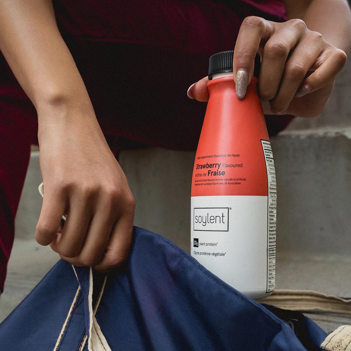 Person holding Soylent Drink Strawberry